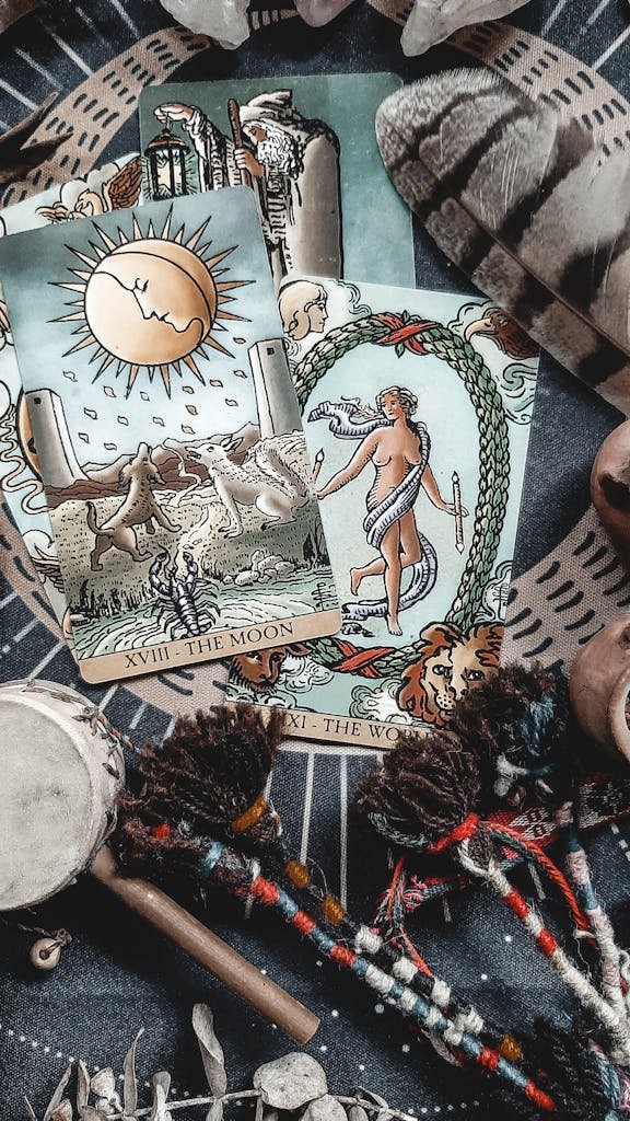 A close-up of mystical tarot cards on a ritualistic cloth, showcasing spiritual elements.