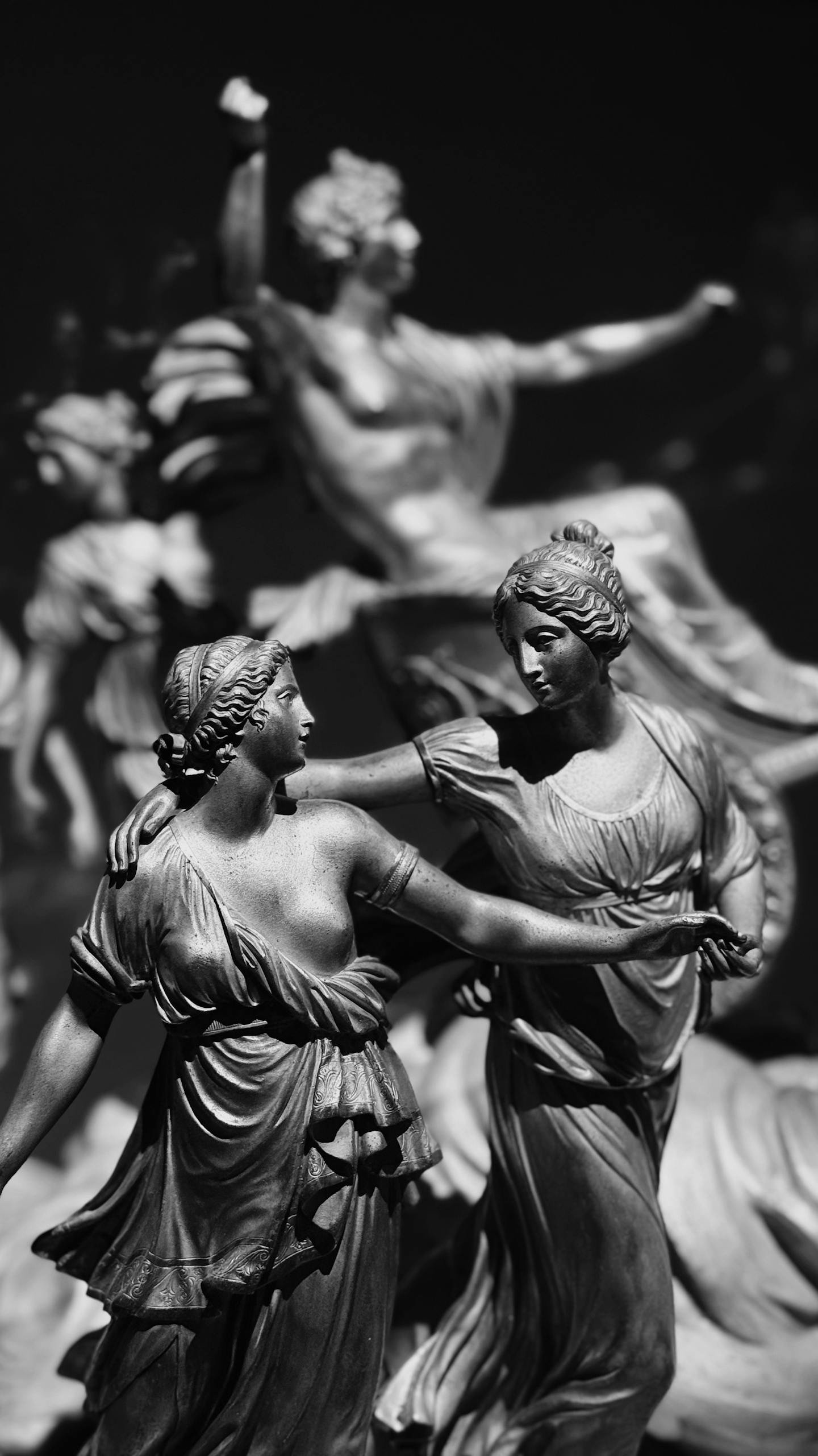 Graceful dance of classical figures captured in monochrome, highlighting intricate details.